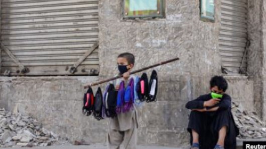 young poor boy selling mask